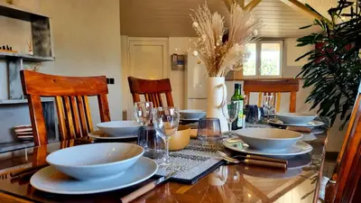 a dining room table with bowls and plates on it at Villa d'Architecte - Cocon Design, Calme & Mer in Fitou