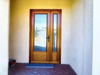 a wooden door with a window in a building at Maison champêtre à Tournissan avec grand jardin in Tournissan