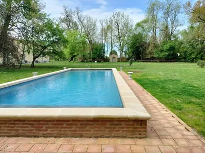 a swimming pool in a yard with a grass field at Gîte de l'Abbé 8 à 10 personnes in Lempaut