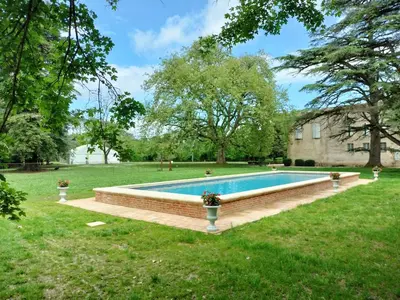 a swimming pool in the middle of a yard at Gîte de l'Abbé 8 à 10 personnes in Lempaut