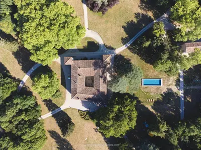 an aerial view of a house with a driveway and trees at Maison de Pierre 4 à 6 personnes in Lempaut