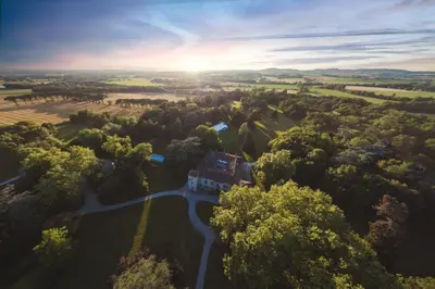 an aerial view of a house in the middle of a forest at Maison de Pierre 4 à 6 personnes in Lempaut