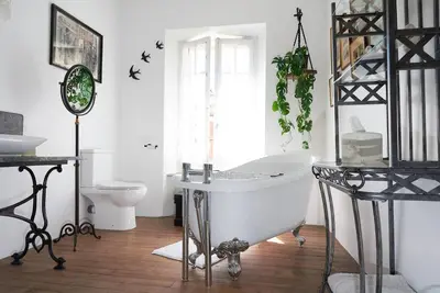 a white bathroom with a tub and a toilet at The French House in Quillan in Quillan