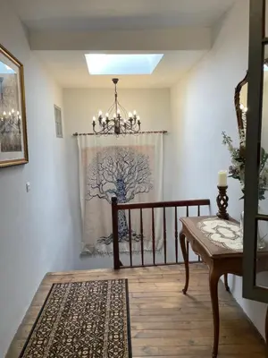 a dining room with a chandelier and a table at The French House in Quillan in Quillan