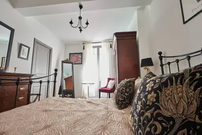 a bedroom with a bed and a dresser and a mirror at The French House in Quillan in Quillan