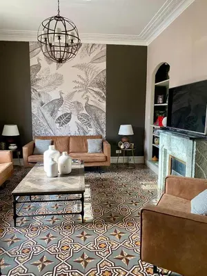 a living room with a couch and a fireplace at Villa Maskali in Cuxac-dʼAude