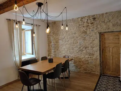 a dining room with a wooden table and chairs at La Terrasse du Temps Jadis in Carcassonne