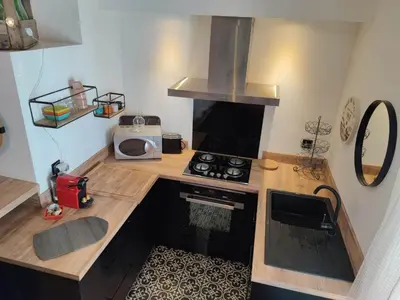 a small kitchen with a stove and a microwave at La Terrasse du Temps Jadis in Carcassonne