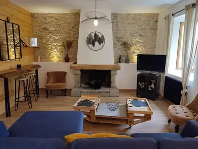 a living room with a fireplace and a blue couch at La Terrasse du Temps Jadis in Carcassonne