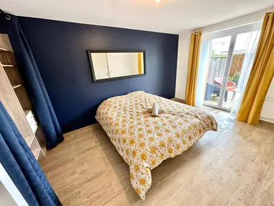 a bedroom with a bed and a mirror on the wall at Evasion dépaysante Canal du Midi * Terrasse & SPA in Castelnaudary