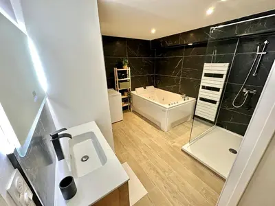 a bathroom with a tub and a sink and a shower at Evasion dépaysante Canal du Midi * Terrasse & SPA in Castelnaudary