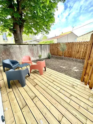 a patio with chairs and a table on a wooden deck at Evasion dépaysante Canal du Midi * Terrasse & SPA in Castelnaudary