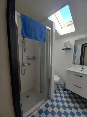 a bathroom with a shower with a glass shower stall at Charmant T2 indépendant in Belcaire